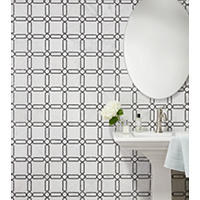Thumbnail image of Wall tiled in Ava with Marquina marble mosaic tile features a white tile with subtle grey veining and black Marquina circular and rectangular accents that form a chain-link design reminiscent of jewelry.  Used as accent wall behind pedestal sink and oval mirror hung above.
