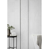 Thumbnail image of White marble wall tile with chevron accent design and black trim in modern bathroom.