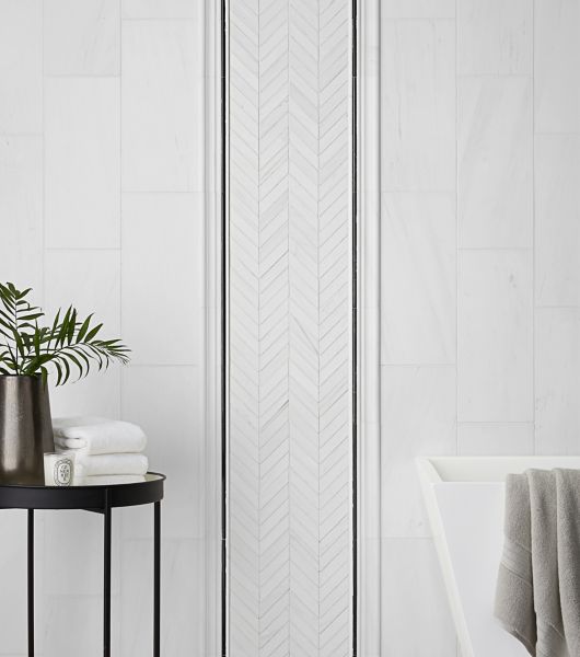 White bathroom wall tile with black accent.