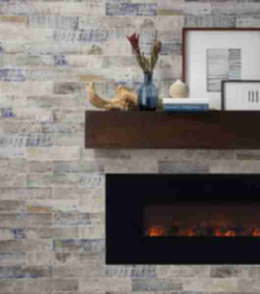 Fireplace surround with the rustic look of weathered wood in a ceramic subway tile set in a horizontal brick pattern. Mantal is a large floating pice of warner toned wood and fire box is matte black.  