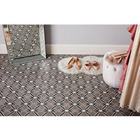 Thumbnail image of Space features an arabesque encaustic floor tile in a black, white and neutral tones with a "X" pattern. The pattern is both soft and hard lines. Mirror shoes and stool are also in space.