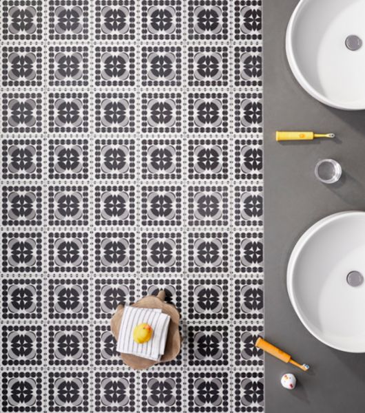 Bathroom floor features shades of black, white and grey. This 8