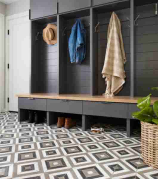 Mudroom with grey and brown geometric mosaic tile adds stunning color and pattern to this tile floor without becoming too busy.