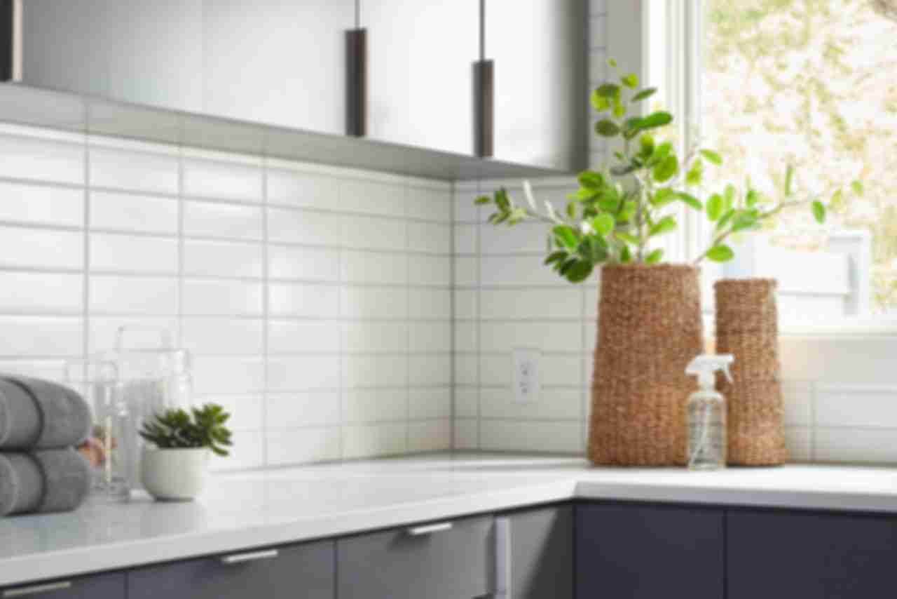 A subway tile backsplash on wall above counter. White subway tile is laid horizontally in stacked columns of tile for a modern and minimalist feel.