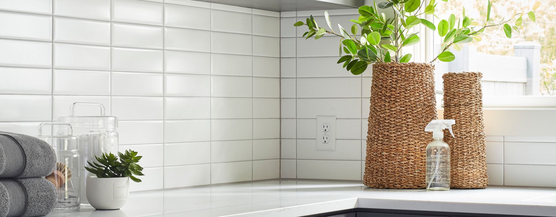 A subway tile backsplash on wall above counter. White subway tile is laid horizontally in stacked columns of tile for a modern and minimalist feel.