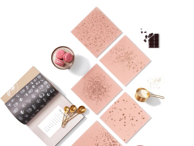 Blush pink glass tile with gold speckles.