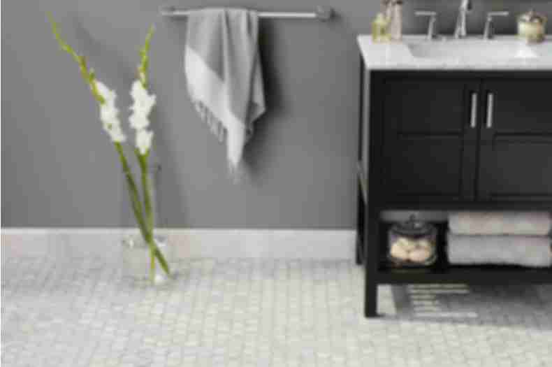 Bathroom with white and grey marble hexagon tile on floor.