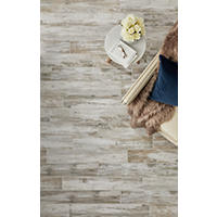 Thumbnail image of These 6" x 35" porcelain planks are designed to offer the same appeal as rustic barn wood with a mixture of taupe, cream and brown tones and a faux-woodgrain texture. Used on floor area.