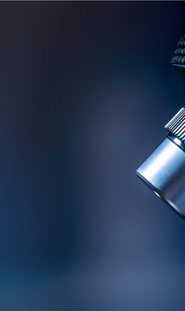 Close up of microscope in laboratory setting with overlaid green abstract pattern on dark background 