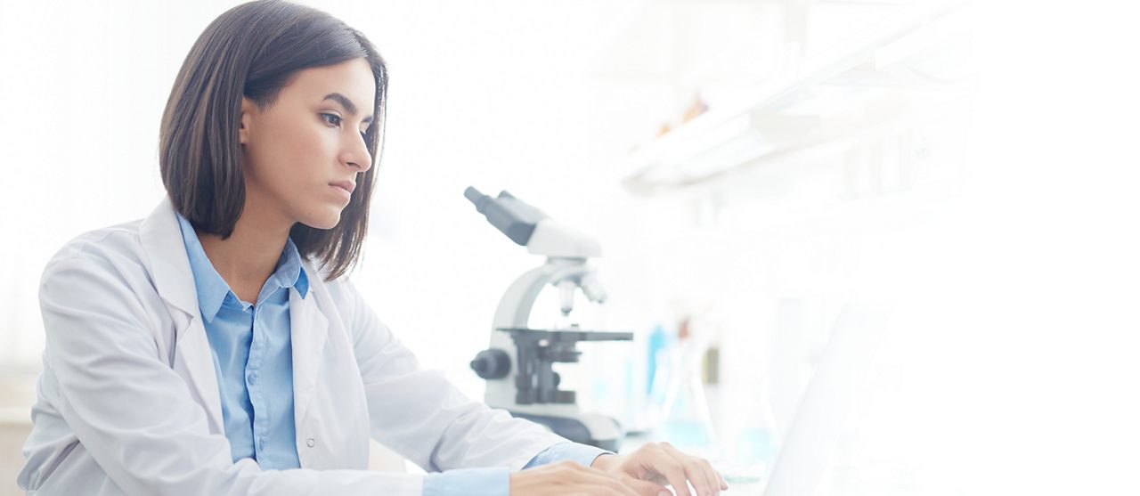 Female doctor typing on a computer