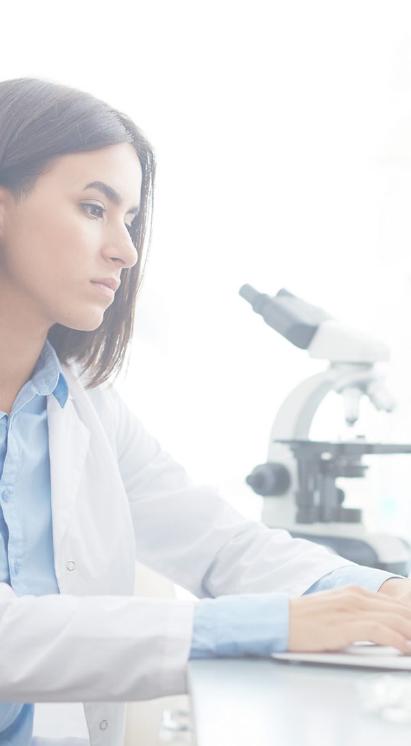 Female doctor typing on a computer