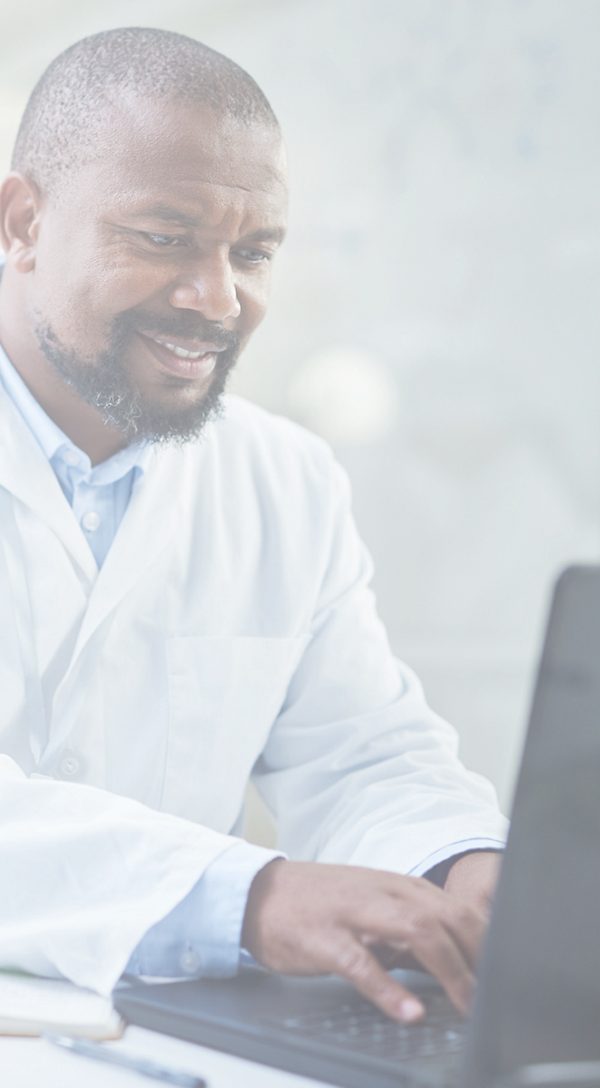  Male doctor typing on a computer