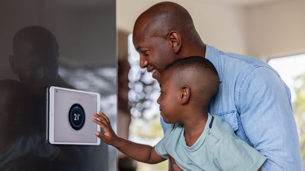 Father and son changing thermostat