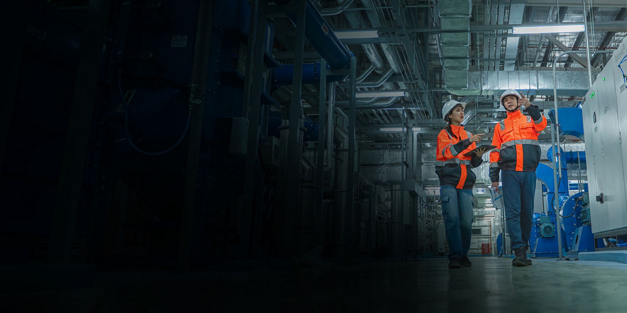 Coworkers during an HVAC inspection in an industrial facility