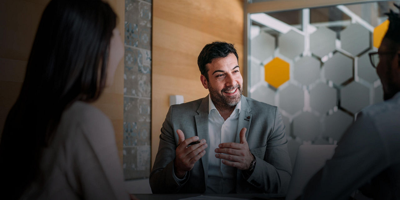 Insurance advisor meeting with a client during a consultation in an office.