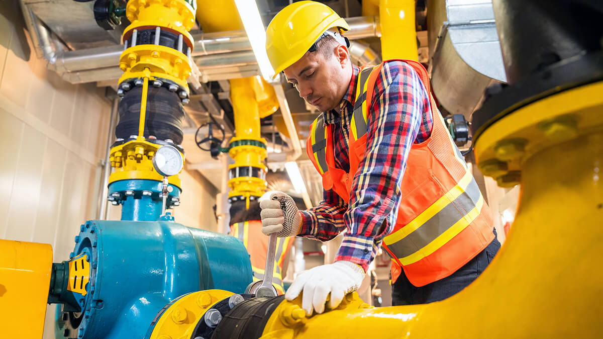 Engineer inspecting industrial equipment in a facility.