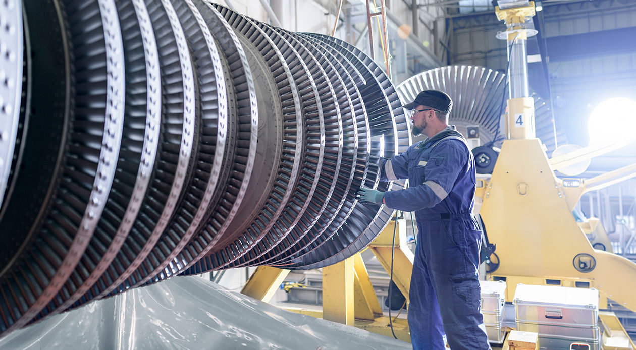 Engineer working on a high-pressure steam turbine in a turbine maintenance factory.