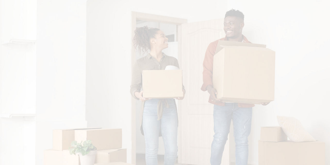 People carrying moving boxes into a new home.