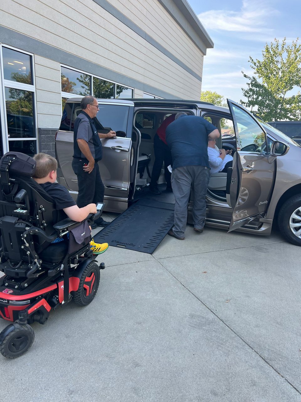 family entering chrysler pacifica van side-entry ramp