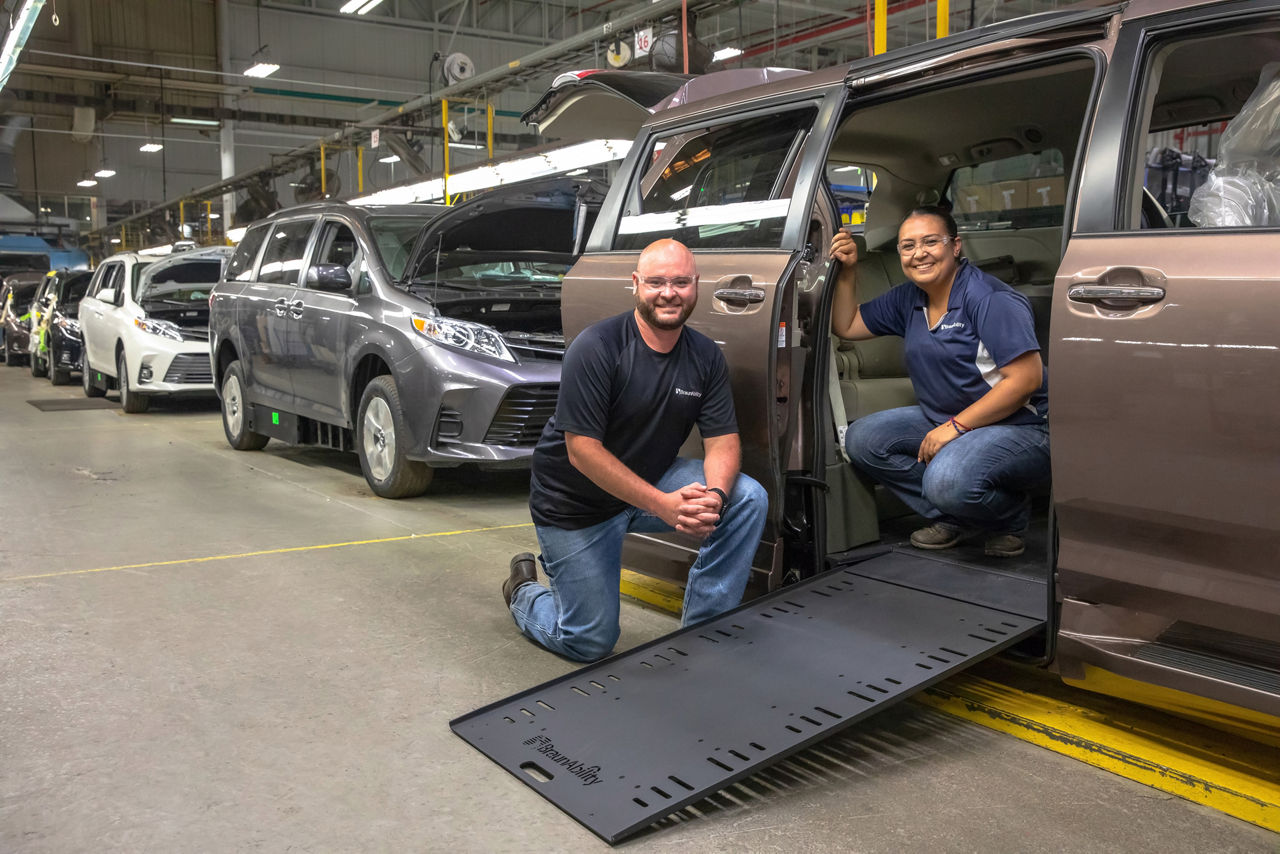 BraunAbility employees with WAV open infloor ramp