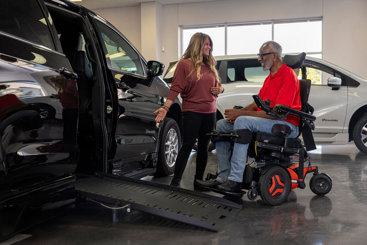 man buying a braunability wheelchair van with mobility specialist