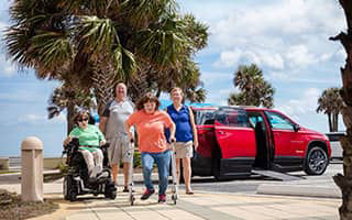 a family with a red chevy traverse wheelchair conversion truck