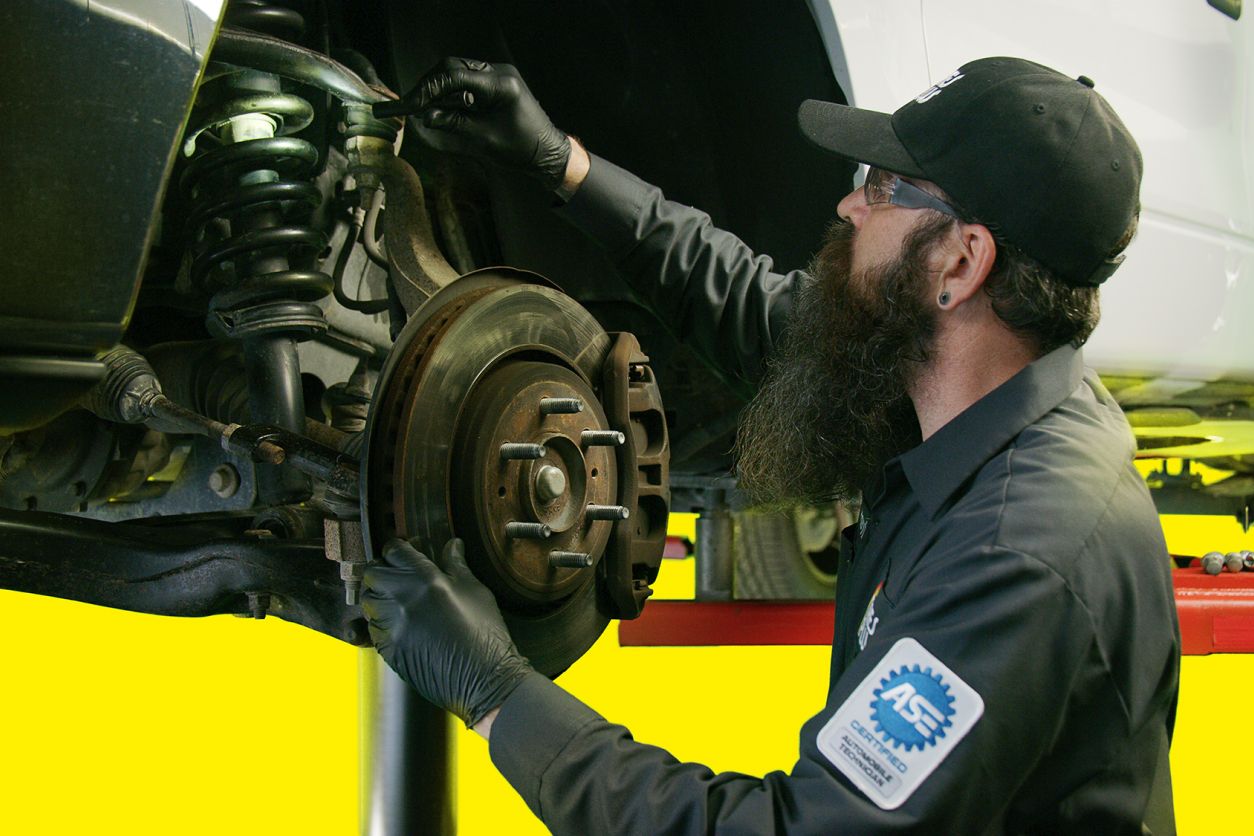 Mechanic reparing the brakes on a car