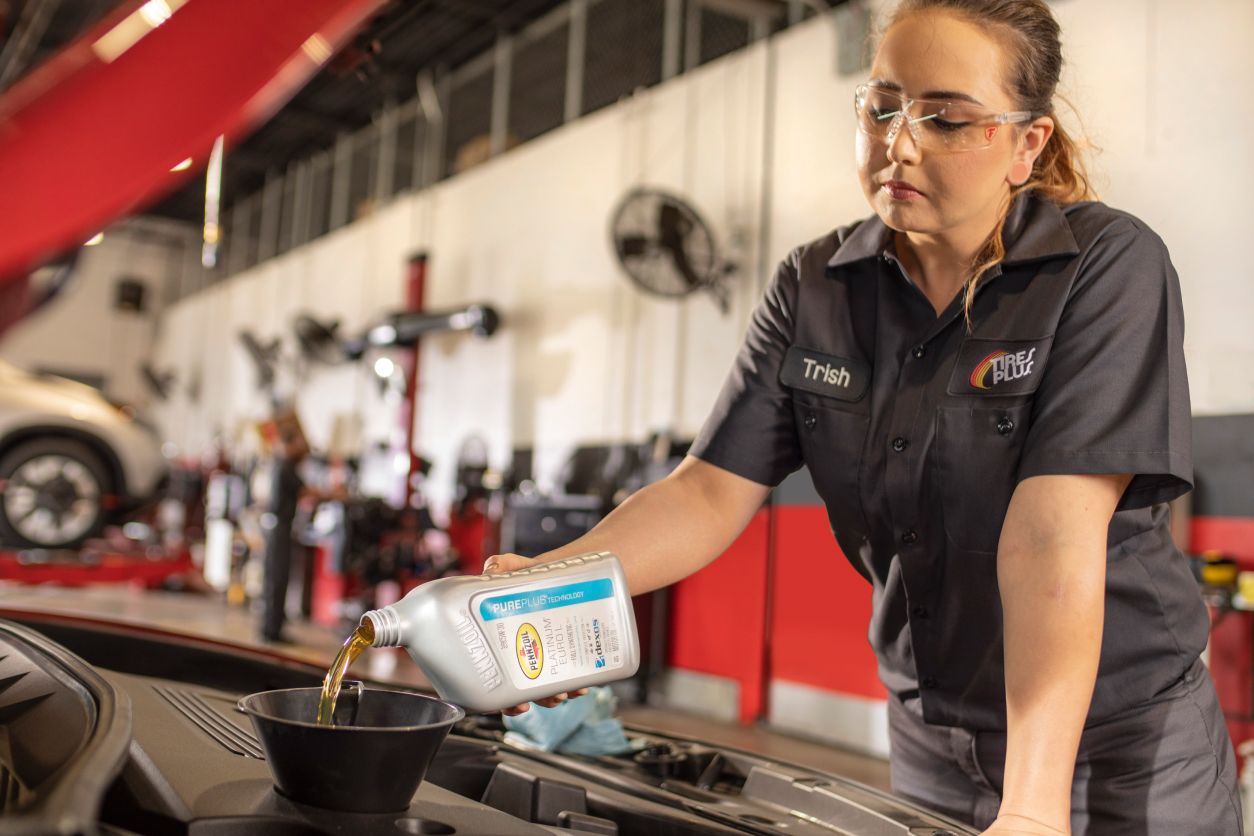 Mechanic changing a cars oil