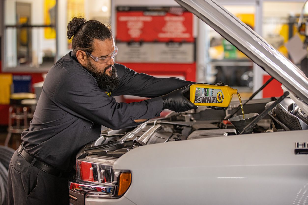 Mechanic changing a cars oil