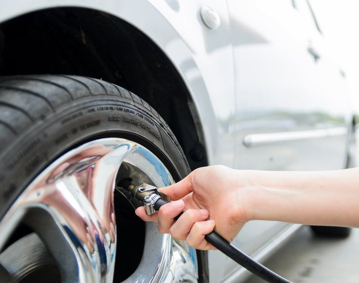 Detail of hand pumping air to tire for increasing tire pressure