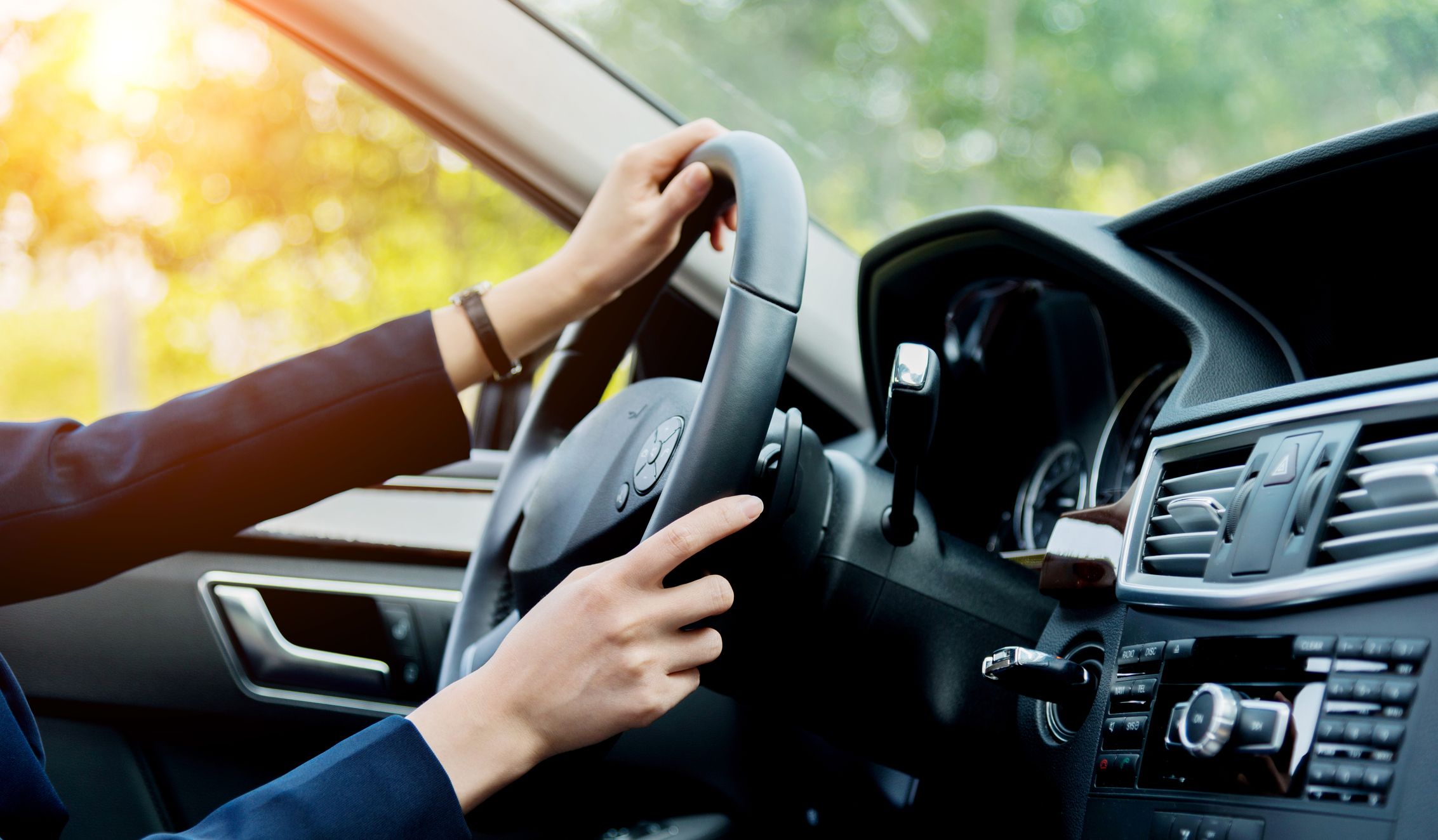 woman in a car turning the steering wheel