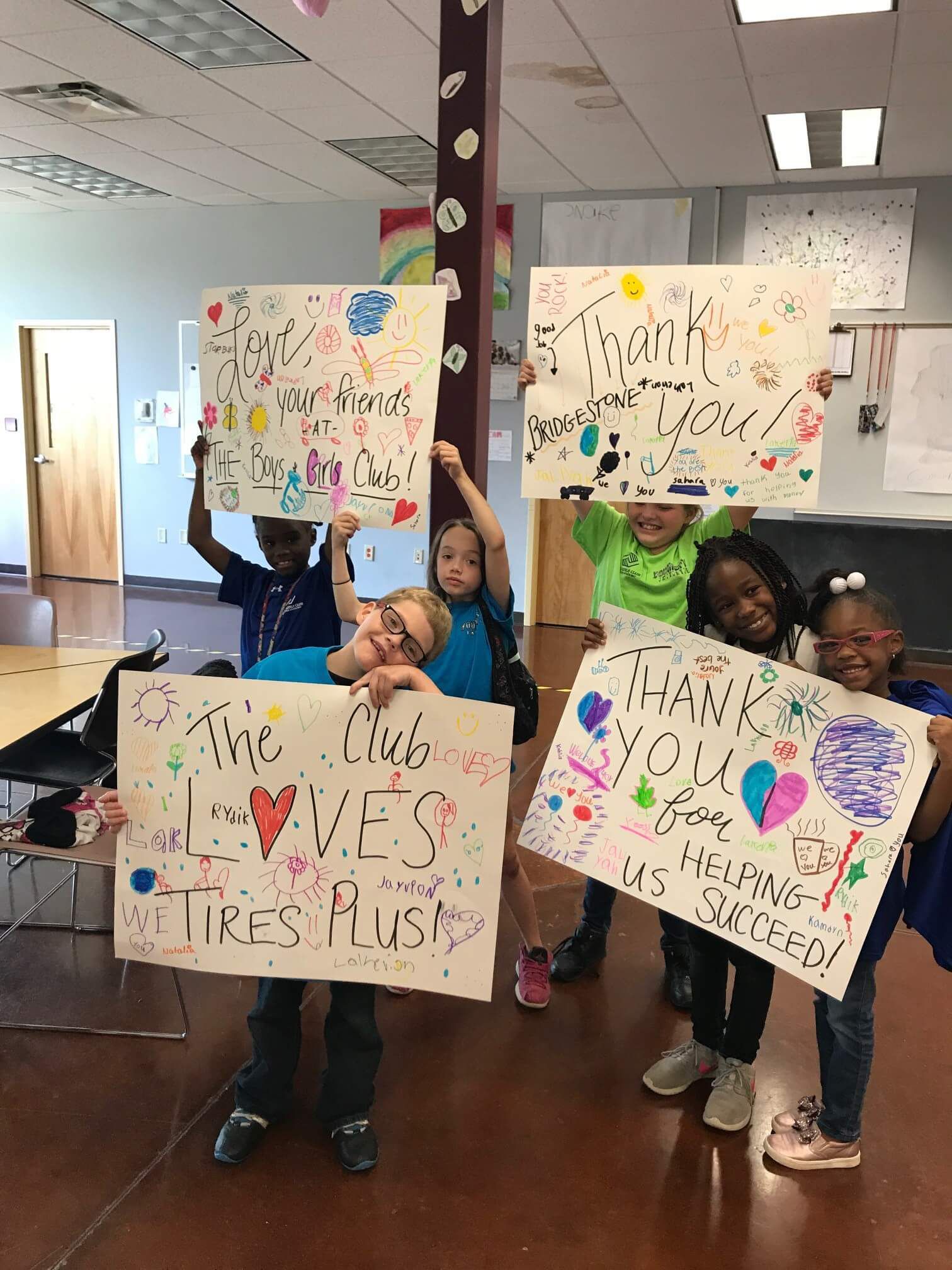 BGC of Green Bay Members Showcase Thank You Signs for Tires Plus