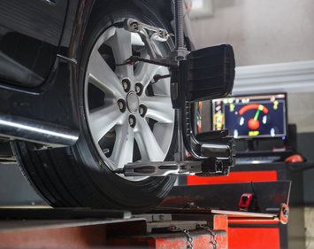 Close up view of tire and wheel during wheel alignment