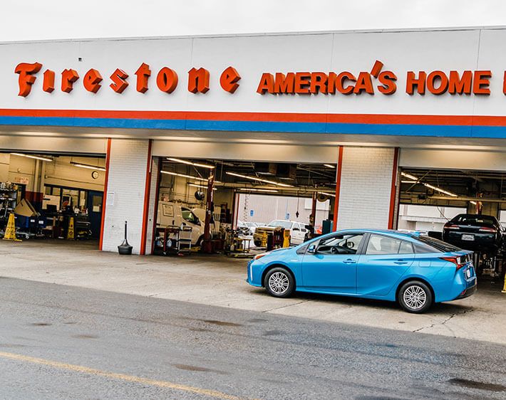 blue car sitting outside Firestone Complete Auto Care