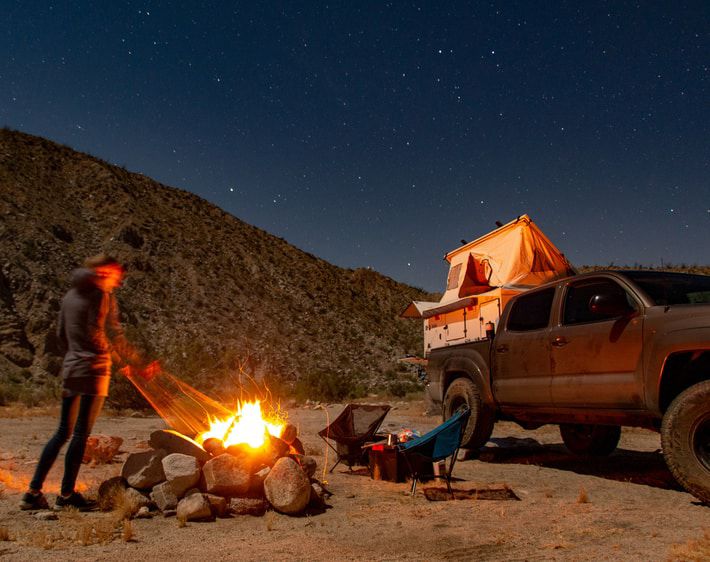 man camping next to truck