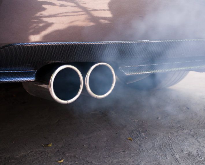 Car exhaust pipe expelling smoke