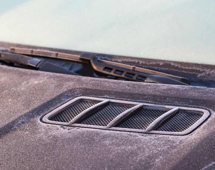 Hood of a black car on a frosty, cold morning