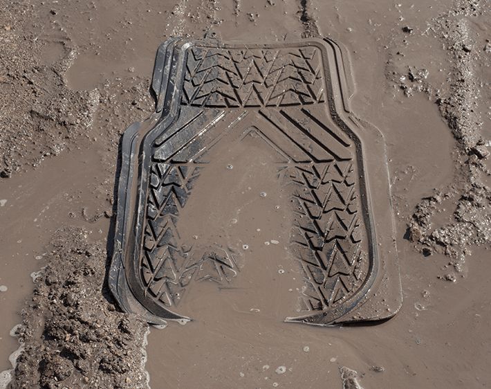 Floor mat of car in mud and water