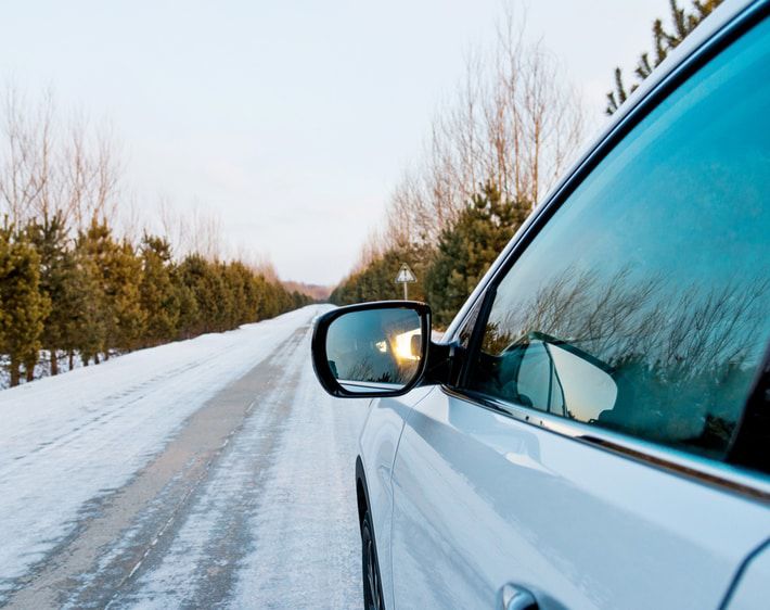 Car driving down icy road