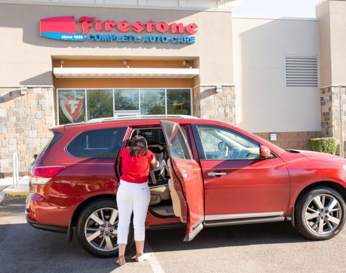 Woman standing in front of a car