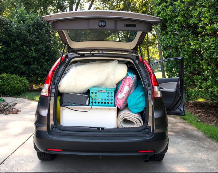 Hatchback trunk of car open, showing car packed and ready for college