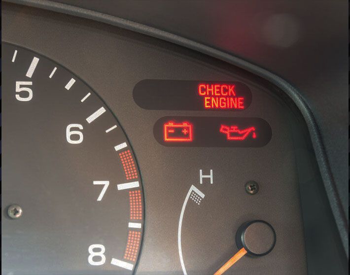 Yellow and black close up of car's check engine light on