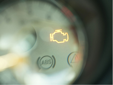 Closeup of check engine light illuminated.