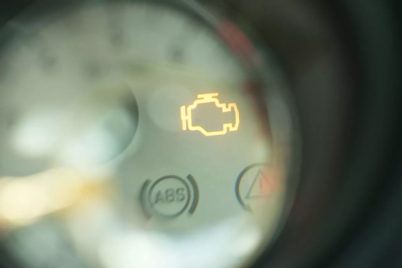 Closeup of check engine light illuminated.