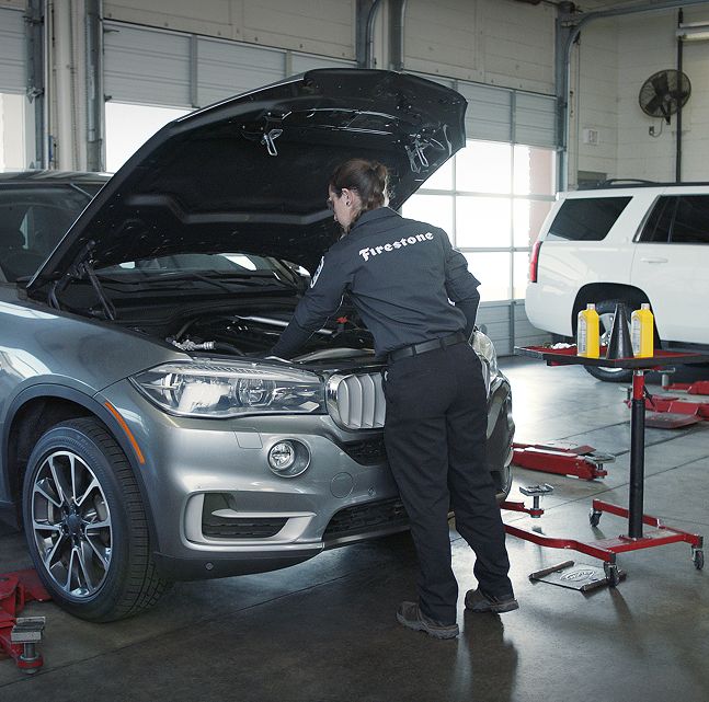 A technician changing oil