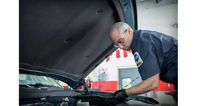 A technician changing oil
