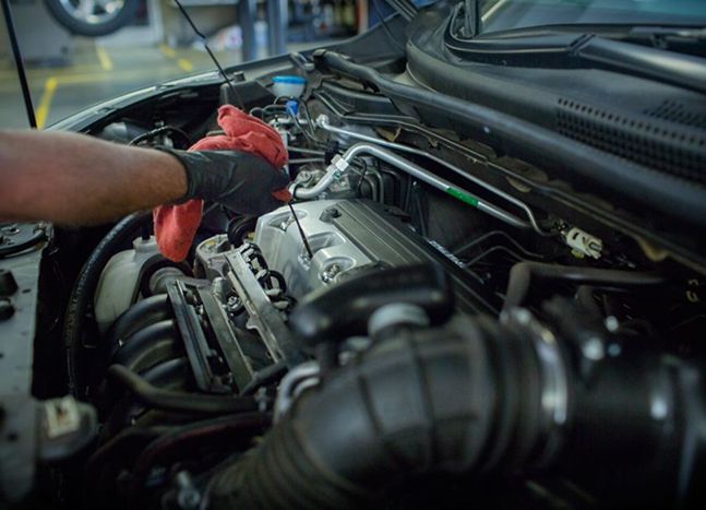 A close-up of under a car's hood.