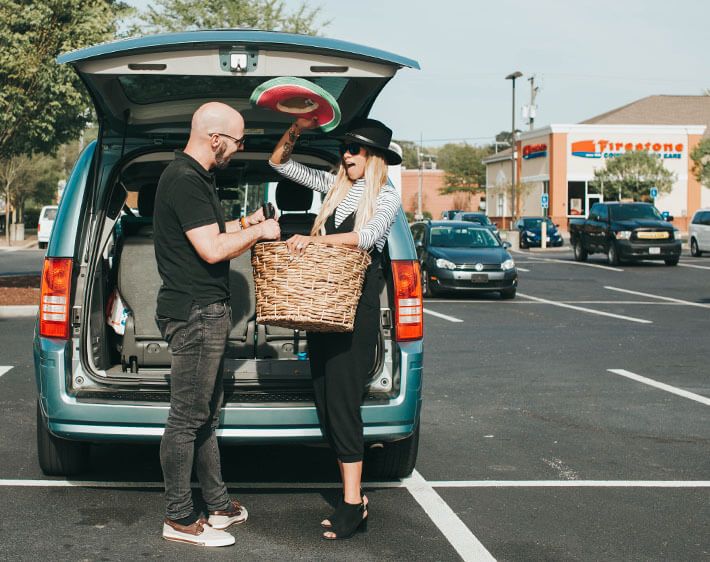 couple cleaning out their car