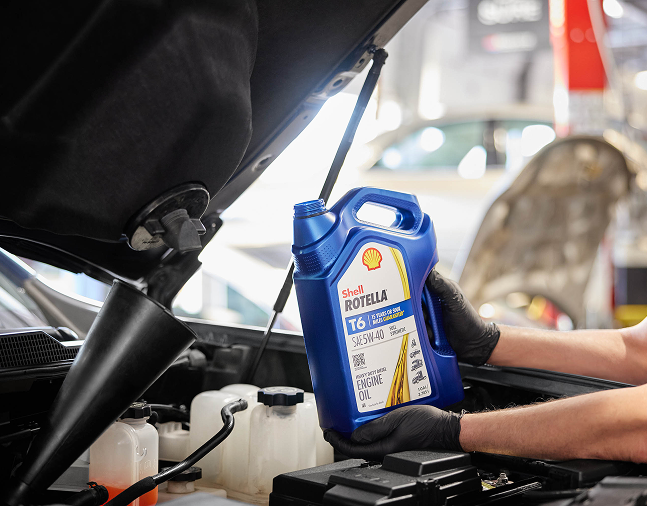 A technician changing oil