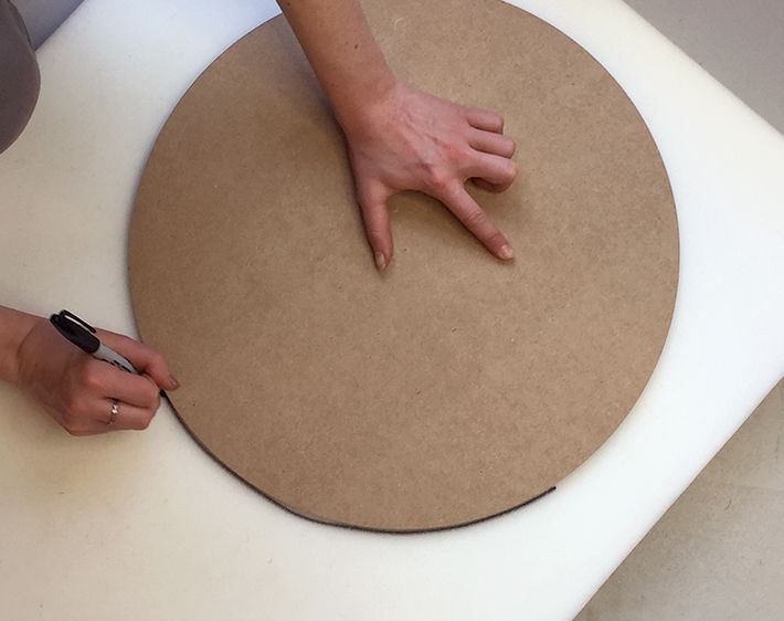 Tracing around the plywood circle on a piece of foam